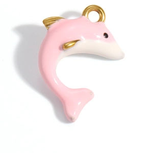 Detailed view of dolphin pendant with pink and white enamel in gold plated finish