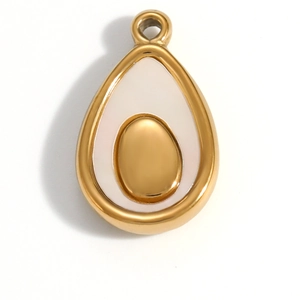 Close-up of gold avocado pendant with white enamel inlay and 18K gold-plated frame