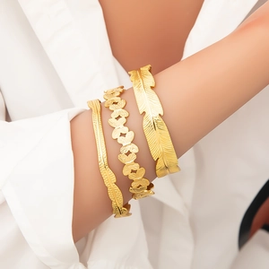 Three-piece set of 18k gold stainless steel bracelets featuring feather and butterfly designs