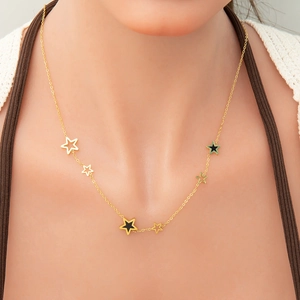 Detail of 18k gold plated necklace featuring varied star pendants on a delicate chain
