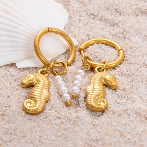 Boucles d'oreilles hippocampe en or 18k avec perles et détails de coquillage