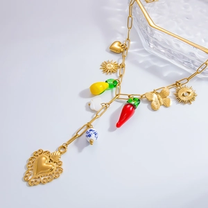 Detail of 18k gold chain necklace with colorful enamel heart, sun, and shell charms