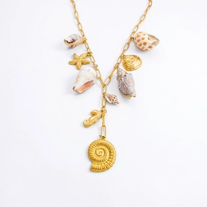 Detailed view of 18k gold necklace with natural shells, starfish, and seahorse charms