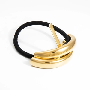 Polished gold metal flower hair tie with minimalist stacked arc design and black elastic