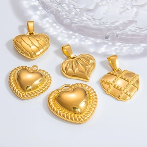 Dettaglio di ciondoli a cuore placcati in oro 18k con vari motivi geometrici strutturati