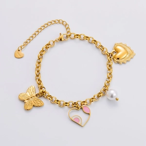 Detail eines vergoldeten Edelstahl-Charm-Armbands mit Schmetterlings- und Herzanhängern