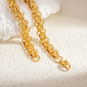 Detailed macro view of 18k gold plated chain bracelet with diamond-cut texture links