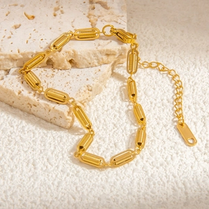 Detail of 18k gold-plated chain bracelet with spiral textured links and lobster clasp