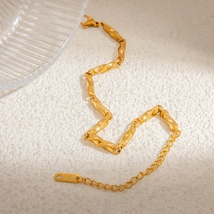 Detailed close-up of 18k gold plated stainless steel chain bracelet with lobster clasp