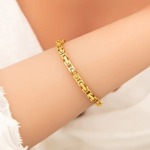 Close-up of a 18k gold plated Byzantine chain bracelet on a female wrist for daily fashion