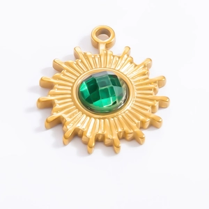 Detailed close-up of 18k gold sunburst pendant with a green gemstone for jewelry DIY