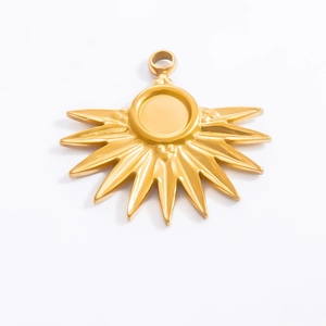 Detailed macro view of 18k gold plated stainless steel sunburst charm with a polished finish