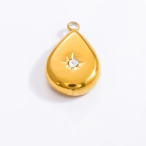 Detailed macro view of gold-plated teardrop pendant with central starburst stone setting