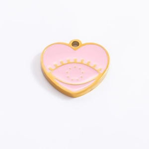 Detailed macro view of heart-shaped pink enamel evil eye pendant in 18k gold finish
