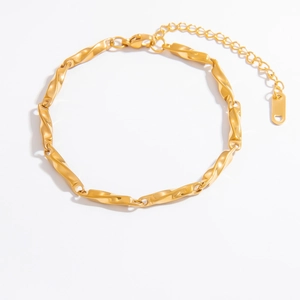 Detail view of 18K gold plated twisted bar chain bracelet with lobster clasp and logo tag