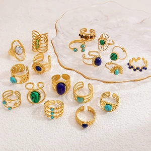 Detailed close-up of retro stainless steel rings with colorful natural stones and gold finish