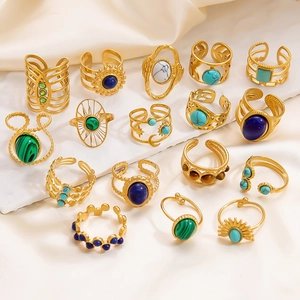 Close-up of gold stainless steel rings set with natural malachite and tiger eye stones