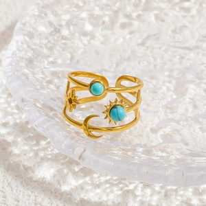 Detail of celestial gold open ring with turquoise stones and star moon elements