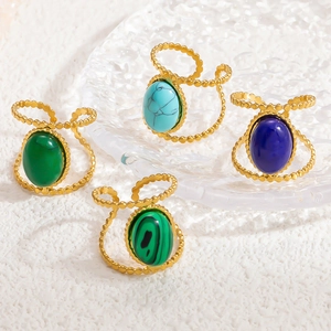 Detailed macro view of retro 18K gold beaded rings featuring varied oval natural stones