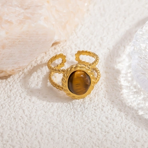 Detailed view of vintage gold ring featuring a large oval tiger eye stone with twisted edge