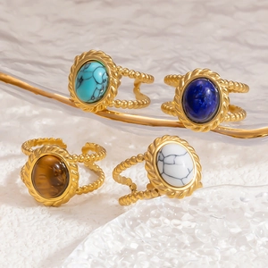 Detail of vintage 18K gold plated rings with colorful oval natural stone inlays