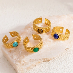Detailed macro view of 18K gold-plated rings featuring natural stones and woven texture
