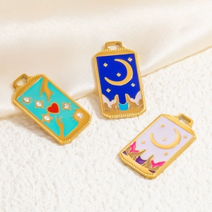 Nahaufnahme von Emaille-Anhängern im Tarot-Stil mit Mond, Sternen und Vergoldung