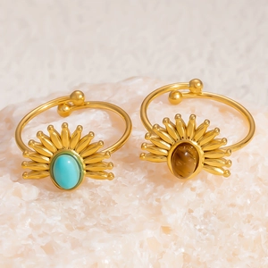 Detail of 18K gold plated rings featuring turquoise and tiger eye stones in sunburst design