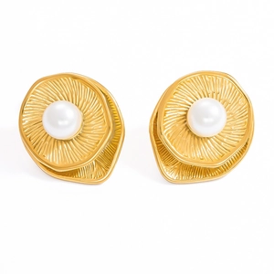 Close-up of 18k gold-plated wavy earrings with elegant white round pearls