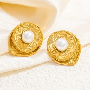 Detail of 18k gold wave earrings with radiating textures and large pearl inlay