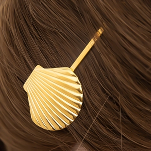 Elegant 18K gold plated stainless steel seashell hair clip on dark brown hair