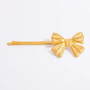 Detailed close-up of 18K gold butterfly hair clip with polished finish and metal texture