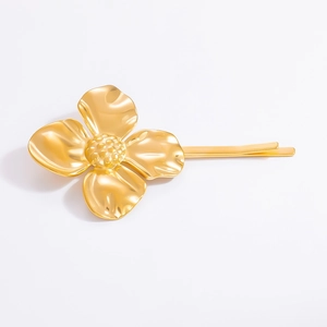 Macro detail of 18K gold stainless steel flower hair clip with textured shell petals