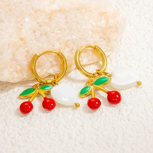 Gros plan de boucles d'oreilles dorées 18K avec cerises rouges et charms de cœur