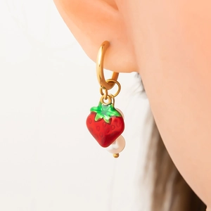 Gros plan détaillé de boucles d'oreilles créoles 18K avec breloque fraise et perle