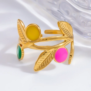 Detailed close-up of golden leaf ring with colorful enamel dots and open adjustable band