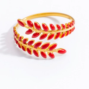 Detailed view of an 18K gold wheat leaf open ring featuring vibrant red enamel detailing