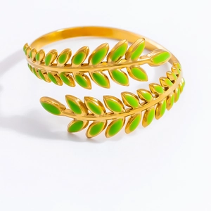 Detailed macro view of an 18K gold olive leaf open ring with green enamel finish