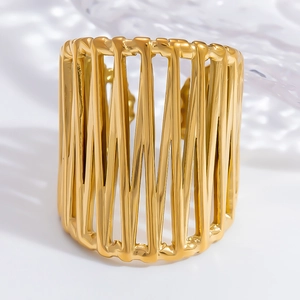 Detailed close-up of wide hollow golden stainless steel ring with vertical bar design