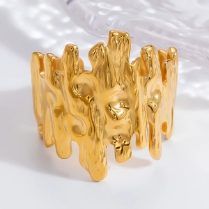 Detail of gold chunky ring with irregular molten texture and high-polished finish