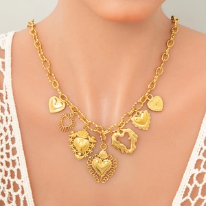 Golden chunky chain necklace with seven diverse heart charms worn by a female model