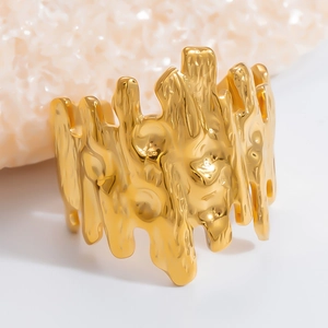 Macro view of gold lava texture ring with irregular surface on stone pedestal
