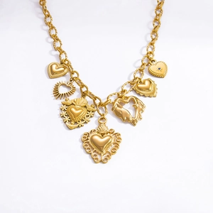 Detailed macro view of a gold chain necklace with various artistic heart-shaped pendants