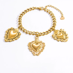 Detail view of golden stainless steel bracelet featuring ornate carved heart-shaped pendants