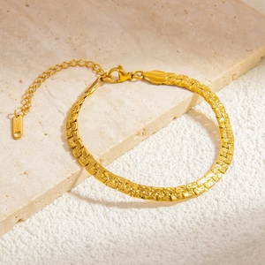 Detailed macro view of gold stainless steel cuban chain with adjustable lobster clasp
