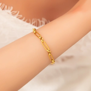 Close-up of 18k gold plated stainless steel paperclip chain bracelet on woman's wrist