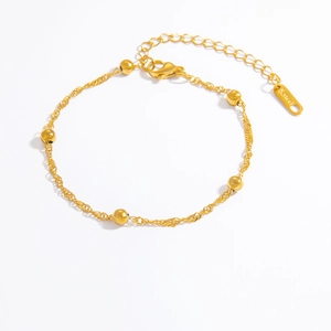 Detailed macro of 18k gold plated stainless steel bracelet with small round beads