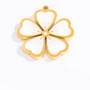 Macro view of a gold-rimmed white enamel cherry blossom pendant with heart petals