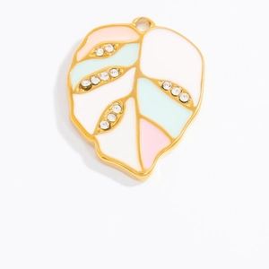 Detail of leaf-shaped jewelry pendant with colorful enamel and sparkling rhinestones