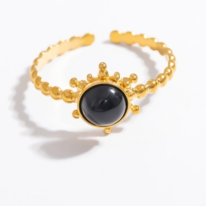 Detail of adjustable gold-plated ring featuring black obsidian stone and beaded edge